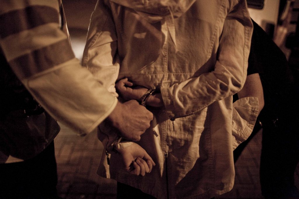 A person being put in handcuffs