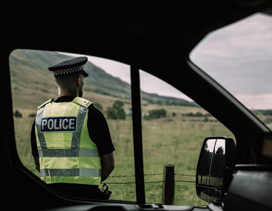 A police officer standing in the countryside