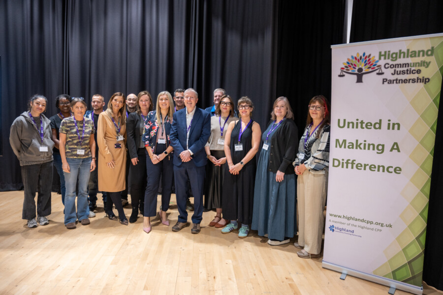 Event organisers, speakers, and Geese Theatre Company performers standing in a semi-circle