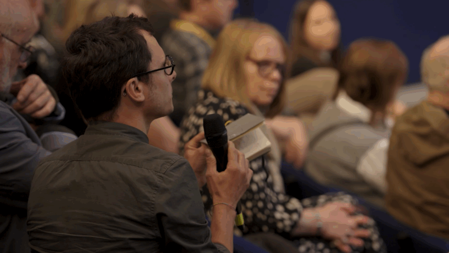 an audience member asking a question at an event