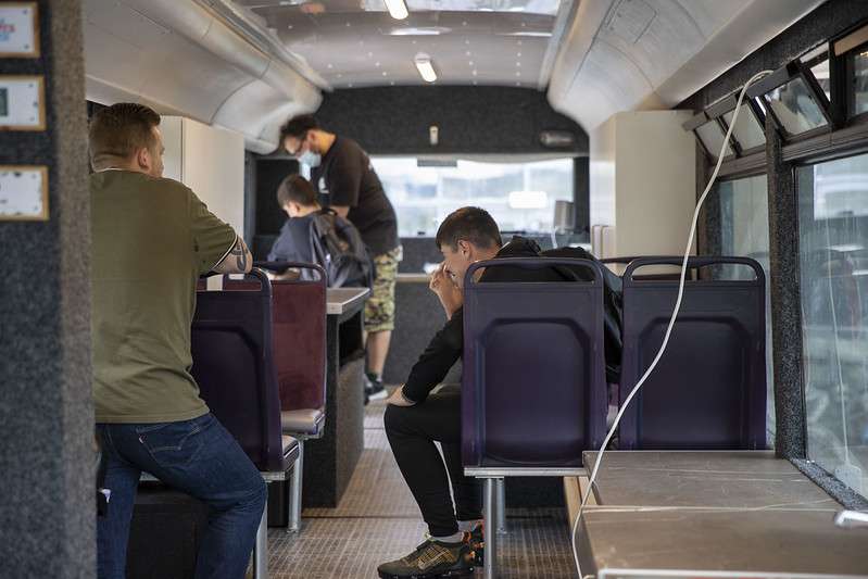 young people being taught DJ skills on a converted bus