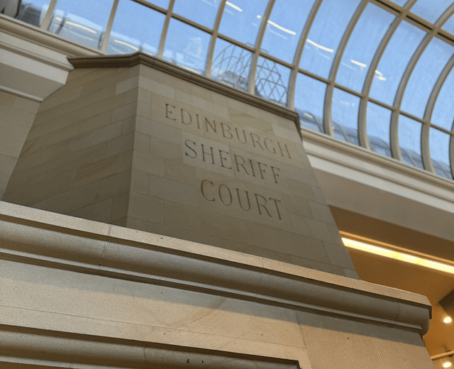 An interior pillar which is inscribed with the words Edinburgh Sheriff Court
